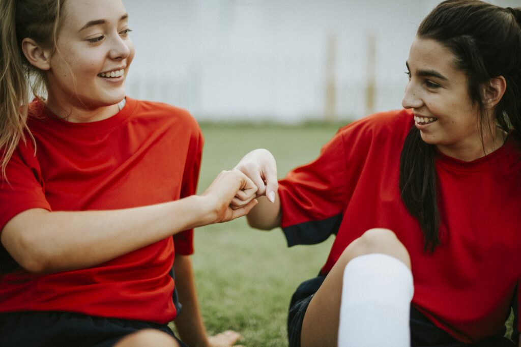 Happy female rugby players doing a fist bump